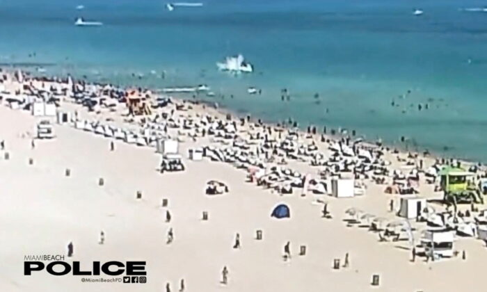 A helicopter crashes into the ocean in Miami Beach, Miami, on Feb. 19, 2022, in this still image obtained from social media video. (Courtesy of Miami Beach Police Department/@MiamiBeachPD via Reuters)