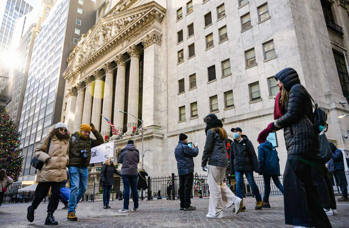 People walk past the New York Stock Exchange (NYSE) in New York City, on Jan. 4, 2022. (Angela Weiss/AFP via Getty Images)