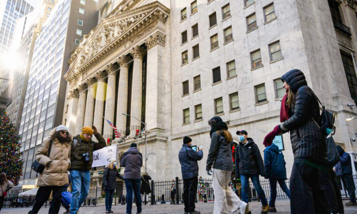 People walk past the New York Stock Exchange (NYSE) in New York City, on Jan. 4, 2022. (Angela Weiss/AFP via Getty Images)