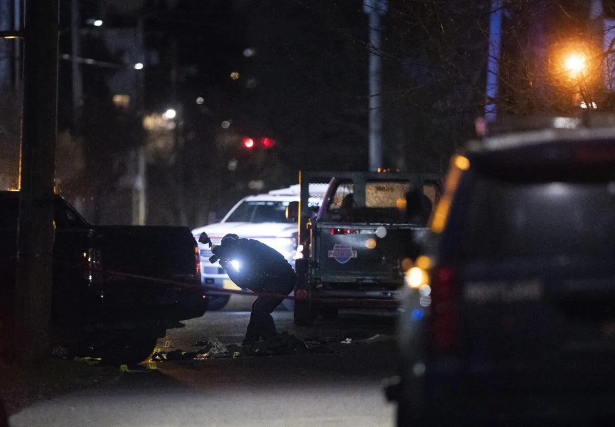 Portland police respond to a shooting in the area of Normandale Park in Portland, Ore., on Feb. 19, 2022. (Beth Nakamura/The Oregonian via AP)