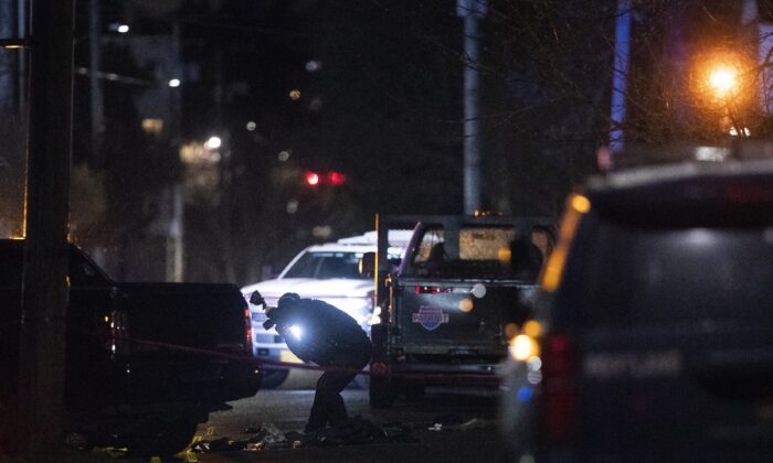 Portland police respond to a shooting in the area of Normandale Park in Northeast Portland, Ore., on Feb. 19, 2022. (Beth Nakamura/The Oregonian via AP)