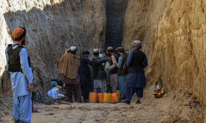 Rescuers try to reach and rescue a boy trapped for two days down a well in a remote southern Afghan village of Shokak, in Zabul province about 120 kilometers from Kandahar, on Feb. 17, 2022. (JAVED TANVEER/AFP via Getty Images)