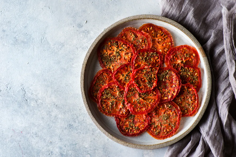 Dehydrating tomatoes takes much less time and work during the summer than making a sauce, and doesn’t overheat the kitchen. (JuliaLavleis/Shutterstock)