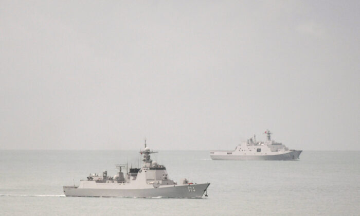 A PLA-N Luyang-class guided missile destroyer (left) and a PLA-N Yuzhao-class amphibious transport dock vessel leave the Torres Strait and enter the Coral Sea on Feb. 18, 2022. (Supplied/Defence Department).