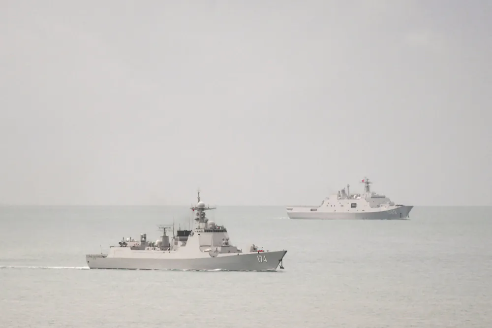 A PLA-N Luyang-class guided missile destroyer (left) and a PLA-N Yuzhao-class amphibious transport dock vessel leave the Torres Strait and enter the Coral Sea on Feb. 18, 2022. (Supplied/Defence Department).