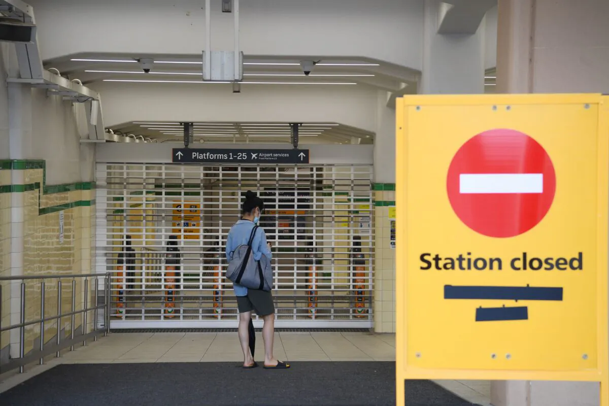 Commuters arrive at the closed Central Station during a planned industrial action by workers at Sydney and NSW Trains in Sydney, Australia, on Feb. 21, 2022. All trains across Sydney and NSW have been cancelled. (AAP Image/Dean Lewins)