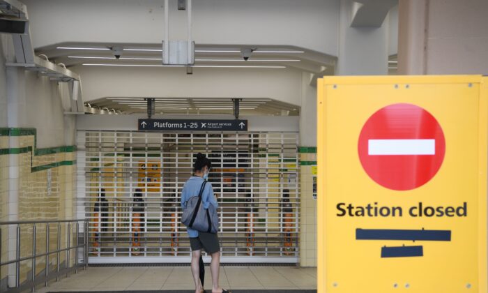 Commuters arrive at the closed Central Station during a planned industrial action by workers at Sydney and NSW Trains in Sydney, Australia, on Feb. 21, 2022. All trains across Sydney and NSW have been cancelled. (AAP Image/Dean Lewins)