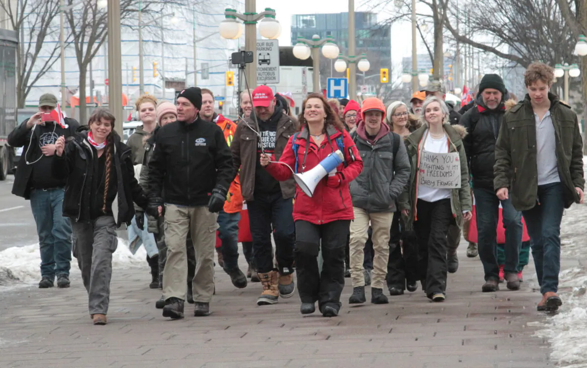 Benita Pedersen, a "Freedom Leader," leads a march around Parliament Hill during the trucker convoy protest in Ottawa in February 2022.  (Richard Moore/The Epoch Times)