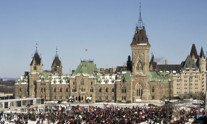Crowds gather on Parliament Hill in protest of COVID-19 vaccine mandates and restrictions, in Ottawa on Feb. 5, 2022. (The Canadian Press/Adrian Wyld)