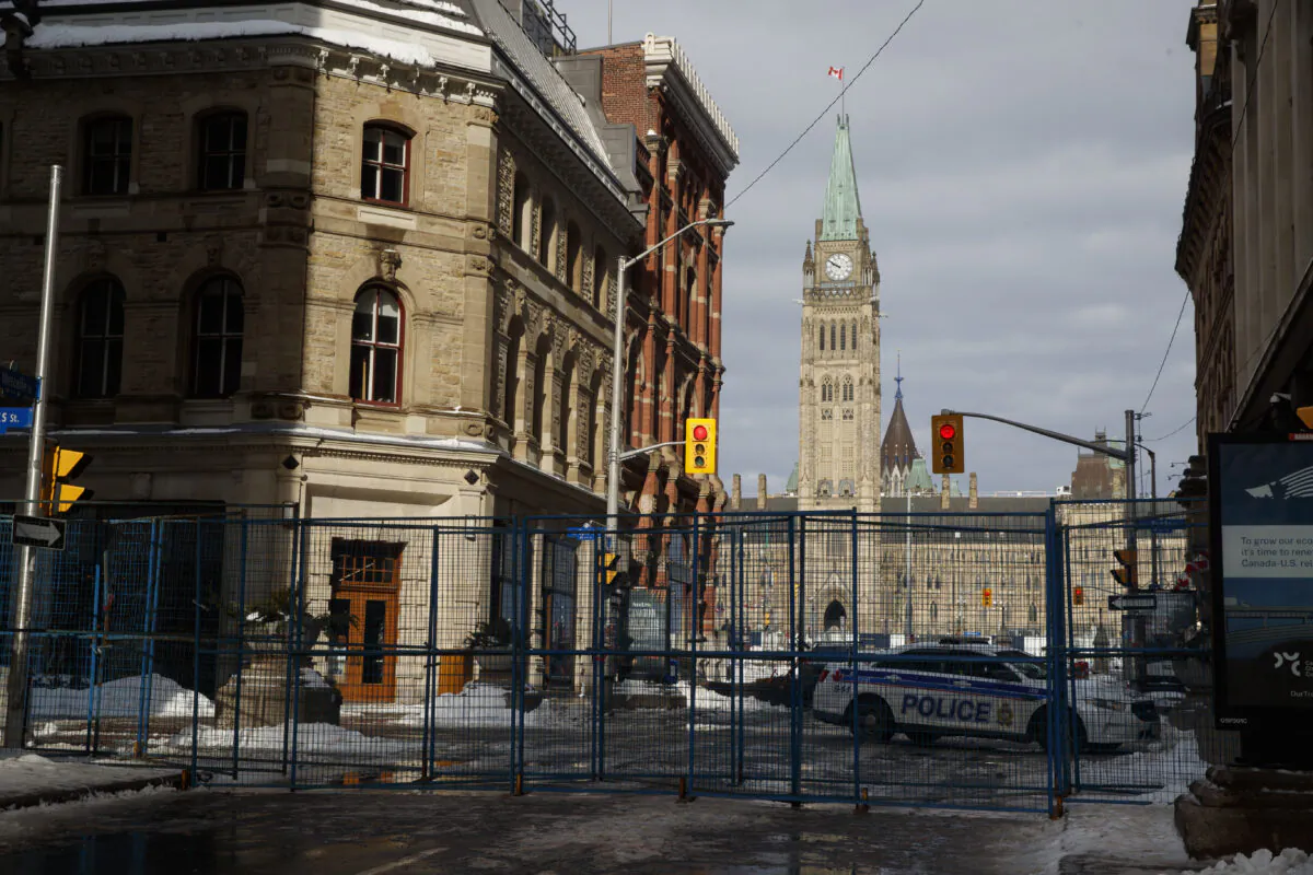 A fence cordons off Parliament Hill after officers cleared a trucker protest that opposes the federal COVID-19 mandates and restrictions, in Ottawa on Feb. 21, 2022. (Cole Burston/The Canadian Press)