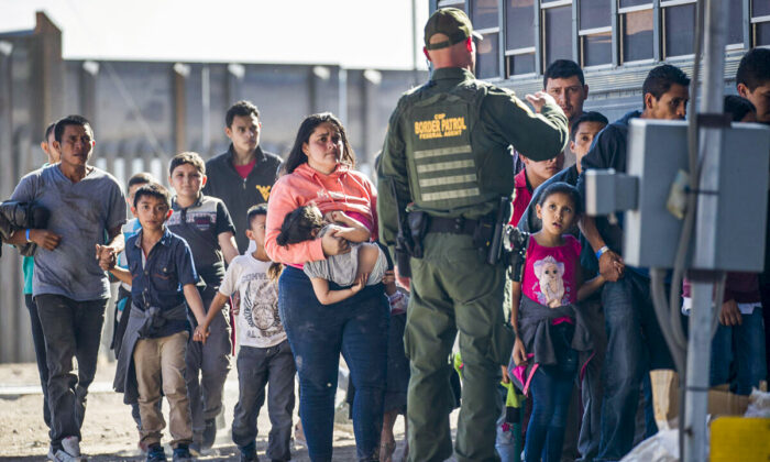 Illegal Immigrants are loaded onto a bus by U.S. Border Patrol agents after being detained when they crossed into the United States from Mexico, in El Paso, Texas, on June 1, 2019. (Joe Raedle/Getty Images)