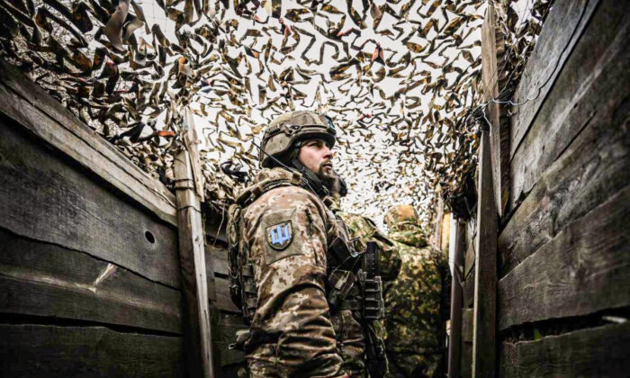 Ukrainian troops patrol at the frontline outside the town of Novoluhanske, eastern Ukraine, on Feb. 19, 2022. (Aris Messinis/AFP via Getty Images)