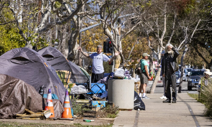 Men emerge from their tents located in a homeless encampment in front of the Abbot Kinney Memorial Branch Library in Venice, Calif., on Feb. 18, 2022. (John Fredricks/The Epoch Times)