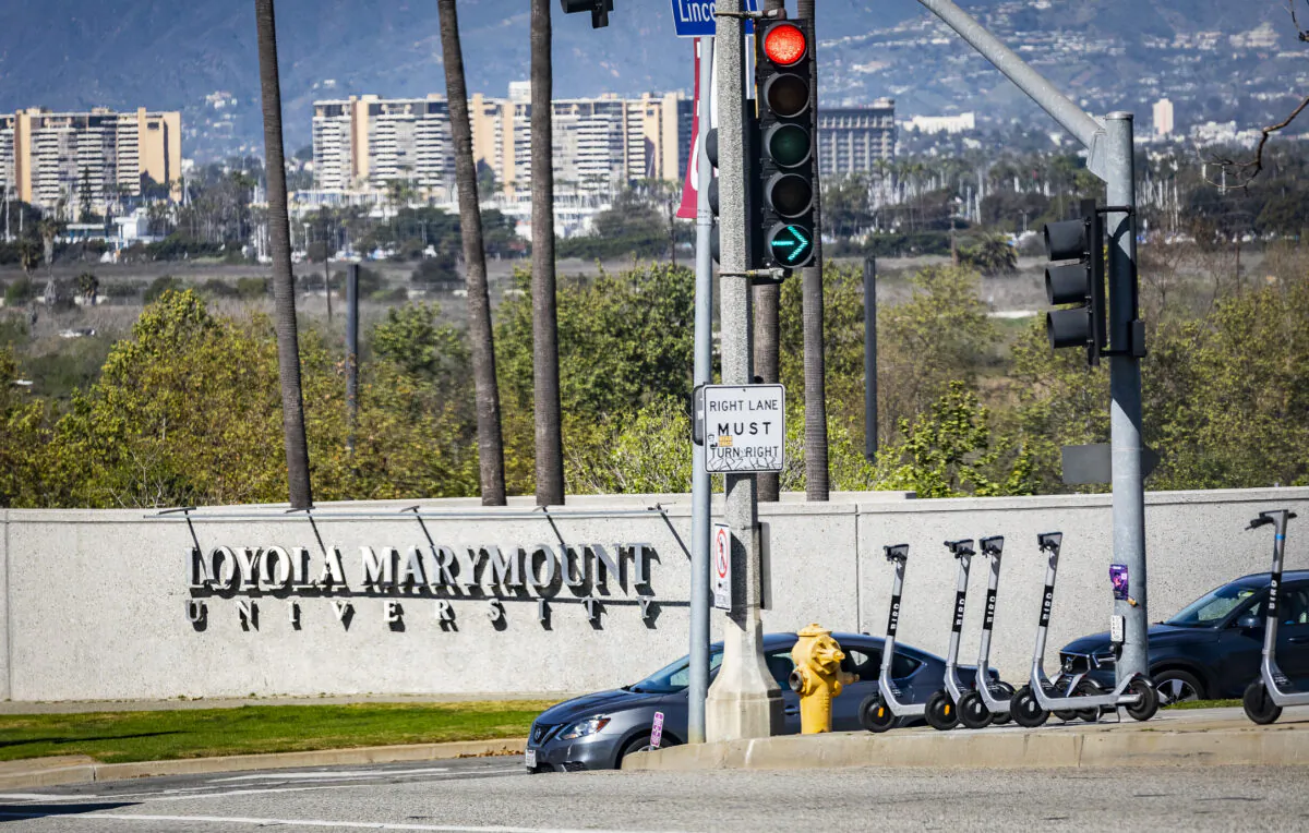 Bird electric scooter rentals in front of the entryway to Loyola Marymount University in Los Angeles on Feb. 18, 2022. (John Fredricks/The Epoch Times)