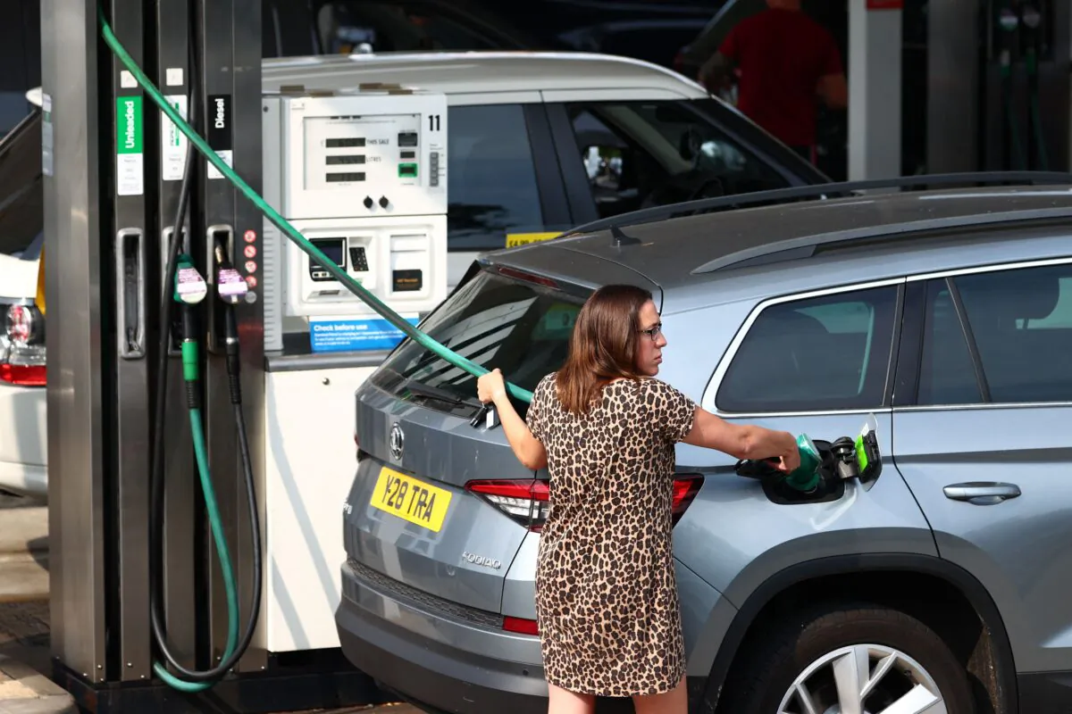 A member of the public fills up her car in Camberley, west of London on Sept. 26, 2021. (Adrian Dennis/AFP via Getty Images)