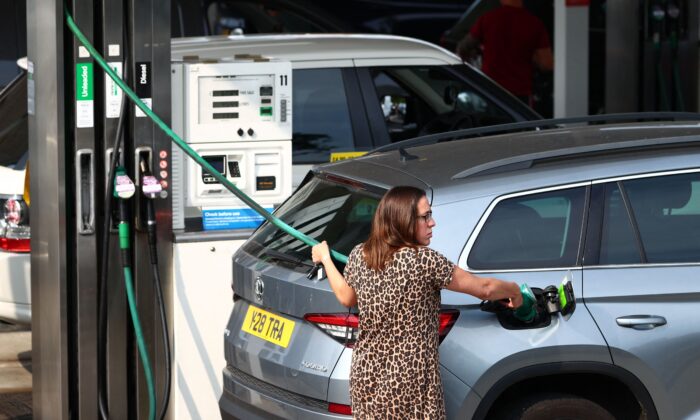 A member of the public fills up her car in Camberley, west of London on Sept. 26, 2021. (Adrian Dennis/AFP via Getty Images)