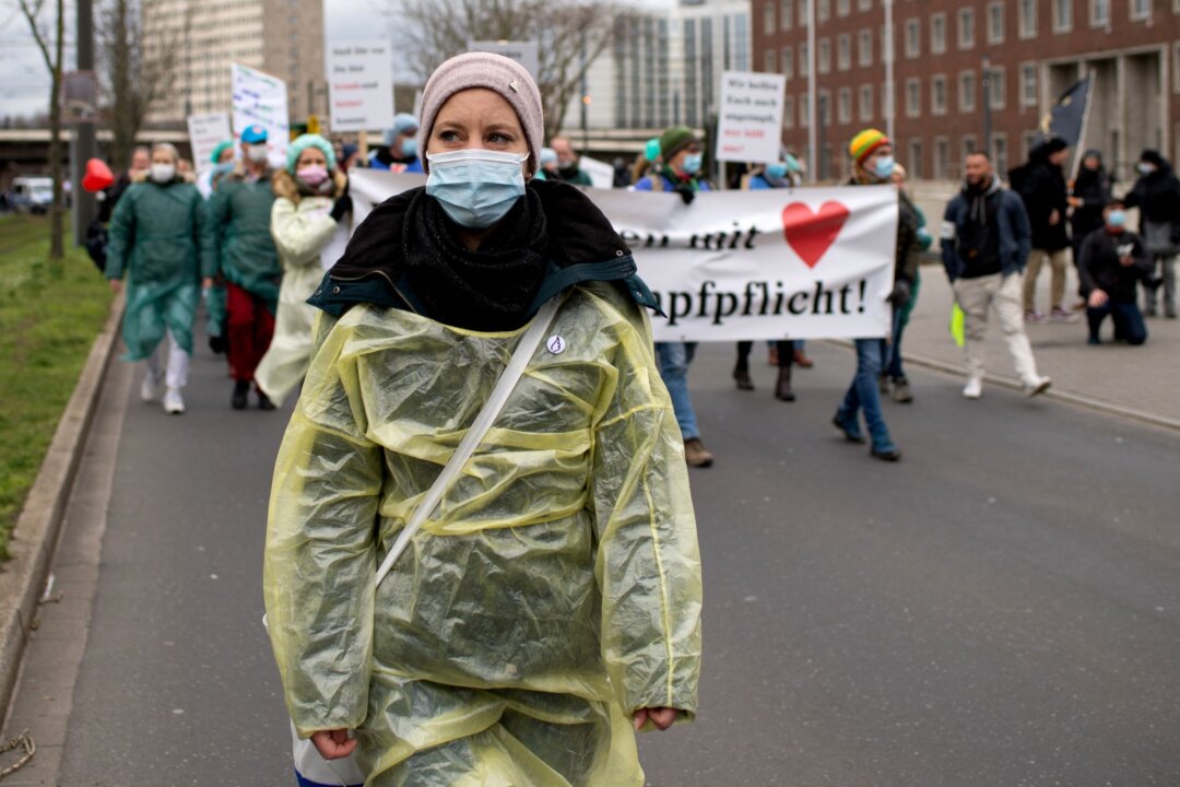 Nurse Stefanie Bresnik and other health workers attend a protest against a mandate for health workers to get vaccinated against COVID-19 in Duesseldorf, Germany, on Feb. 19, 2022. (Max Brugger/Reuters)