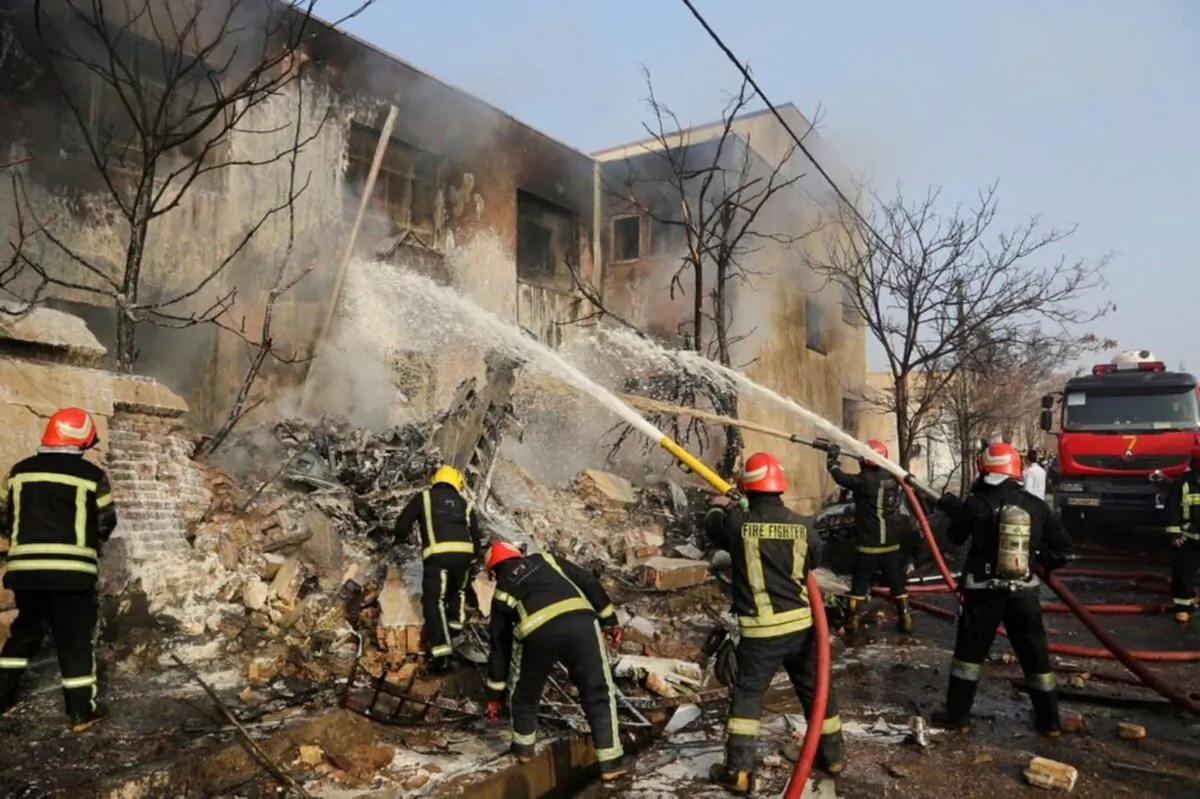 Firefighters work to put out the fire after a fighter jet crashed in Tabriz, Iran, on Feb. 21, 2022. (Tasnim News/WANA (West Asia News Agency) via Reuters)
