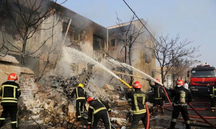 Firefighters work to put out the fire after a fighter jet crashed in Tabriz, Iran, on Feb. 21, 2022. (Tasnim News/WANA (West Asia News Agency) via Reuters)