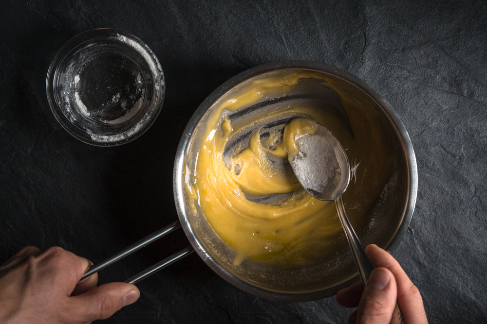 Adding,Flour,To,The,Melted,Butter,On,A,Gray,Table