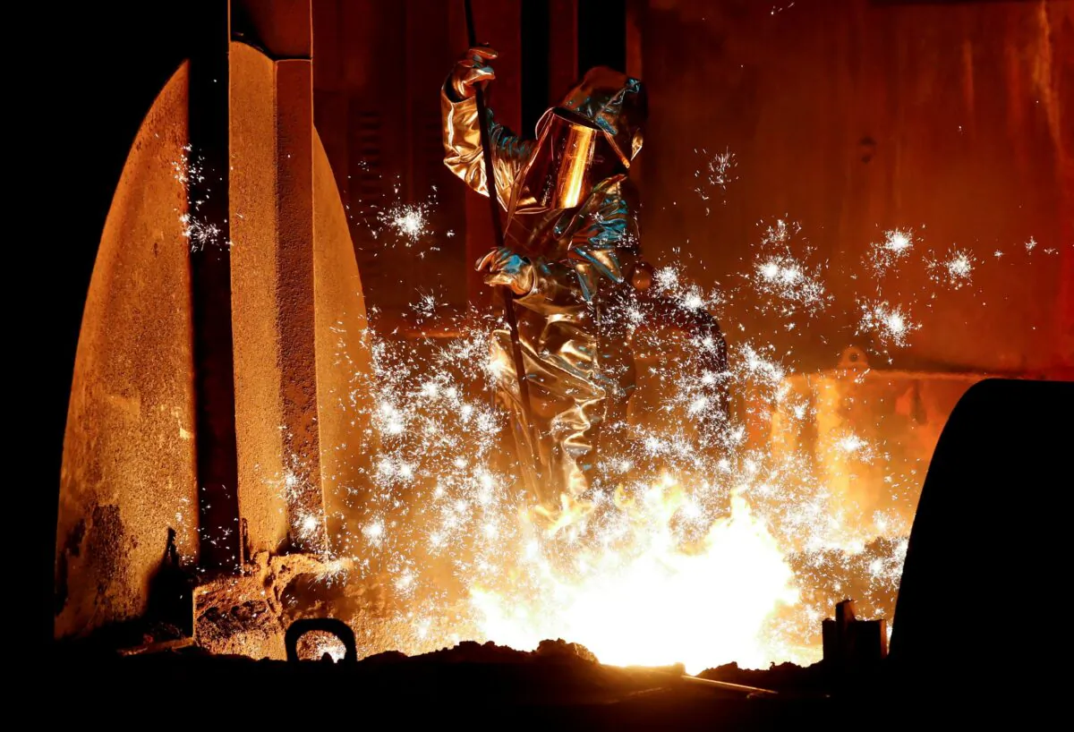 A steel worker for Germany's industrial conglomerate ThyssenKrupp AG takes a sample of raw iron from a blast furnace at Germany's largest steel factory in Duisburg, Germany, on Jan. 28, 2019. (Wolfgang Rattay/Reuters)