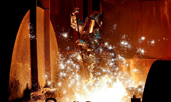 A steel worker for Germany's industrial conglomerate ThyssenKrupp AG takes a sample of raw iron from a blast furnace at Germany's largest steel factory in Duisburg, Germany, on Jan. 28, 2019. (Wolfgang Rattay/Reuters)