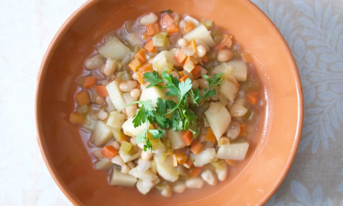 Chunky root vegetables, hearty beans, and a flavorful, no-waste broth come together in this extra nourishing soup. (Victoria de la Maza)