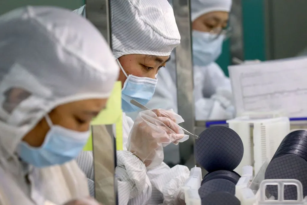 Employees make chips at a factory of Jiejie Semiconductor Company in Nantong, in eastern China's Jiangsu province on March 17, 2021. (STR/AFP via Getty Images)