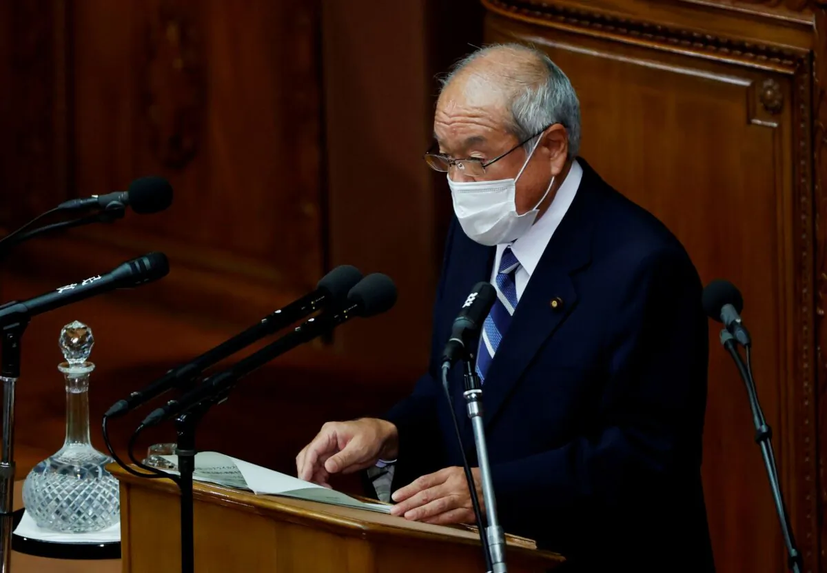 Japan's Finance Minister Shunichi Suzuki wearing a protective face mask delivers his policy speech during the start of an extraordinary session of the lower house of the parliament, amid the coronavirus disease (COVID-19) pandemic, in Tokyo, Japan, on Dec. 6, 2021. (Issei Kato/Reuters)