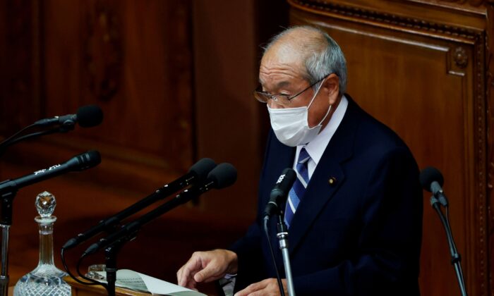 Japan's Finance Minister Shunichi Suzuki wearing a protective face mask delivers his policy speech during the start of an extraordinary session of the lower house of the parliament, amid the coronavirus disease (COVID-19) pandemic, in Tokyo, Japan, on Dec. 6, 2021. (Issei Kato/Reuters)