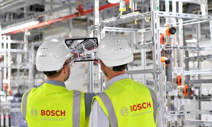 Technicians supervise operations at the new Bosch 300-millimeter wafer fab for silicon chips in Dresden, Germany, on May 31, 2021. (Matthias Rietschel/Reuters)