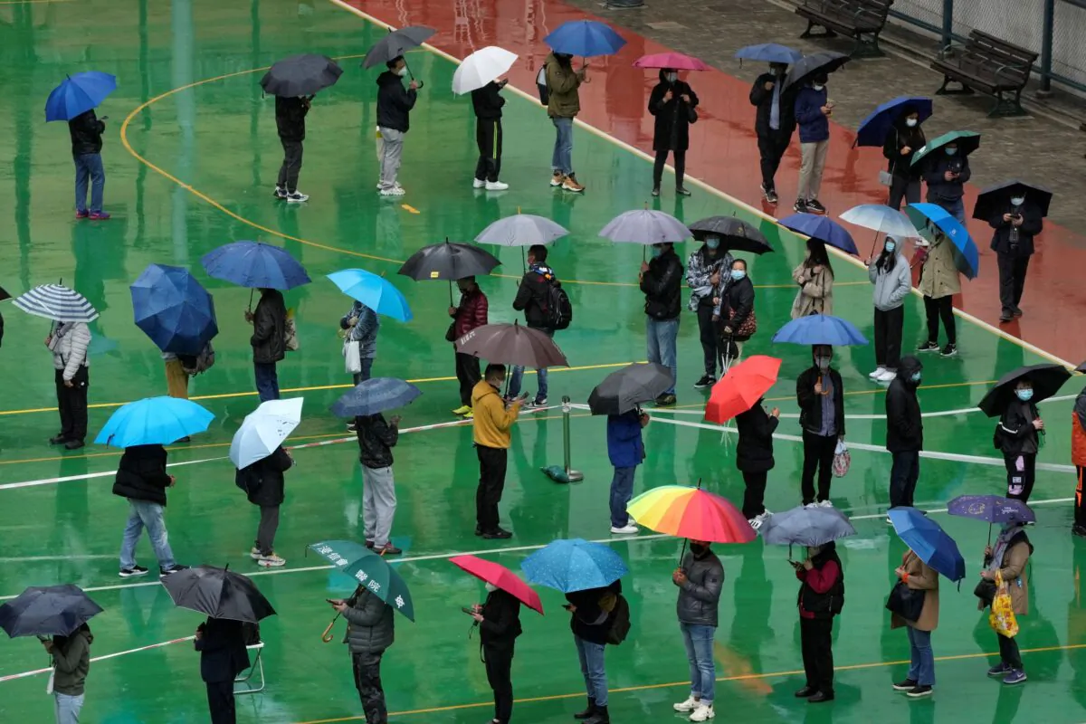 Residents line up to get swabbed for coronavirus testing at a temporary testing center in Hong Kong, on Feb. 22, 2022. (Kin Cheung/AP Photo)