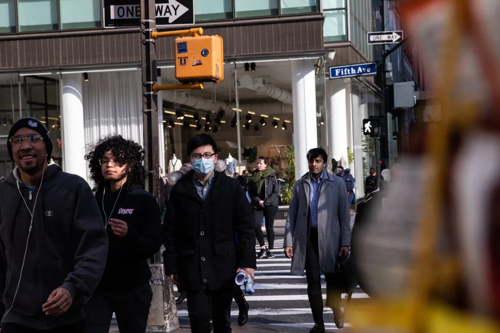 People walk on a street in New York City on March 13, 2020. (Jeenah Moon/Getty Images)