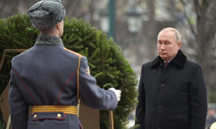 Russian President Vladimir Putin takes part in a wreath laying ceremony at the Tomb of the Unknown Soldier by the Kremlin Wall on the Defender of the Fatherland Day in Moscow, Russia Feb. 23, 2022. (Sputnik/Aleksey Nikolskyi/Kremlin via Reuters)