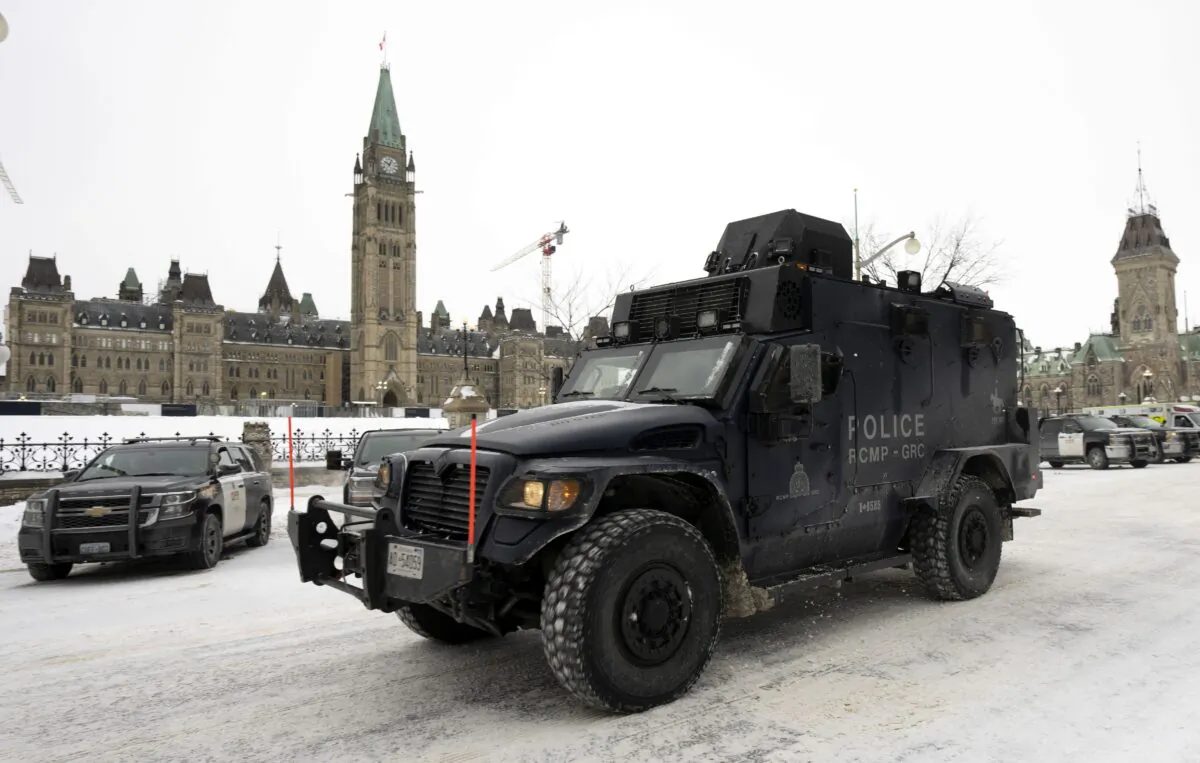 An RCMP tactical vehicle drives past the Parliament Buildings after a massive police operation quelled the Convoy Protest in Ottawa, on Feb. 20, 2022. (The Canadian Press/Adrian Wyld)