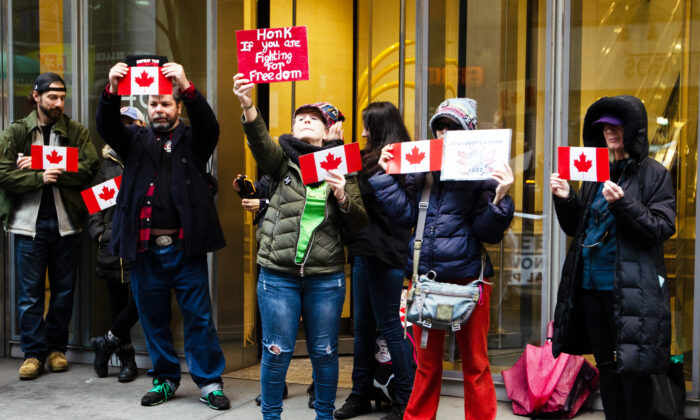 New Yorkers rally in solidarity of the Canadian truckers outside the Canadian Consulate’s building in midtown Manhattan on Feb. 22, 2022. (Dave Paone/The Epoch Times)
