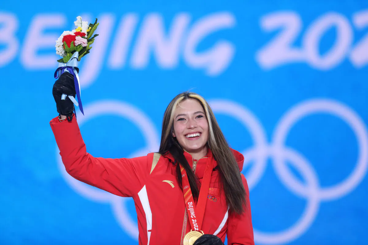 Gold medallist Eileen Gu, a U.S.-born athlete, celebrates with her medal on behalf of the Chinese team during the Women's Freeski Halfpipe medal ceremony on Day 14 of the Beijing 2022 Winter Olympic Games at the Medal Plaza in Zhangjiakou, China, on Feb. 18, 2022. (Ezra Shaw/Getty Images)