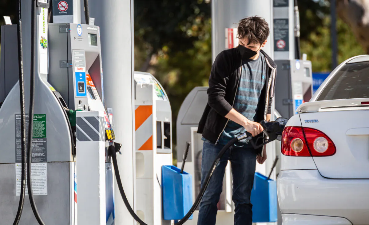 A man pumps gas at a gas station in Irvine, Calif., on Feb. 23, 2022. (John Fredricks/The Epoch Times)