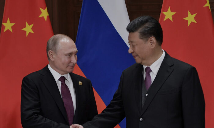 Russia's President Vladimir Putin shakes hands with China's leader Xi Jinping during their meeting at Friendship Palace in Beijing on April 26, 2019. (Alexey Nikolsky/AFP via Getty Images)