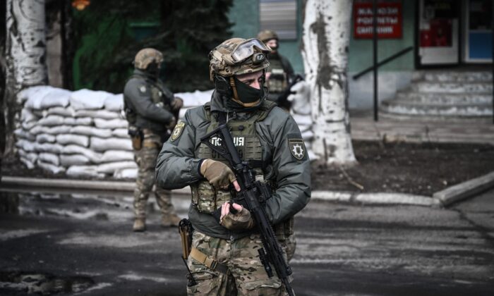 Ukrainian troops patrol in the town of Novoluhanske, eastern Ukraine, on Feb. 19, 2022. (Aris Messinis/AFP via Getty Images)