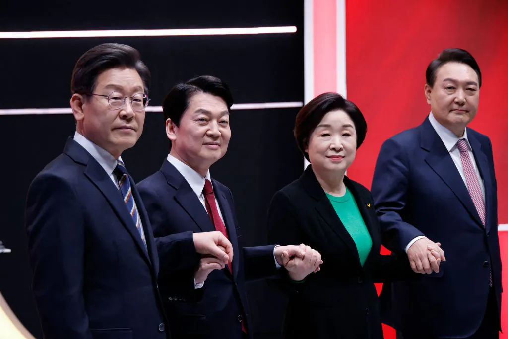 L-R: Lee Jae-myung, presidential candidate of the ruling Democratic Party, Ahn Cheol-soo, presidential candidate of the minor opposition People's Party, Sim Sang-jung, presidential candidate of the Justice Party, and Yoon Suk-yeol, presidential candidate of the main opposition People Power Party, pose for a photo before a televised debate for the upcoming March 9 presidential election in Seoul on Feb. 21, 2022. (Heo Ran/POOL/AFP via Getty Images)