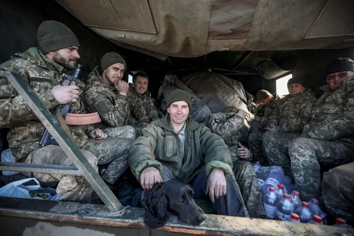 Ukraine's military servicemen sit in the back of military truck in the Donetsk region town of Avdiivka, on the eastern Ukraine front-line with Russian-backed separatists on Feb. 21, 2022. (Aleksey Filippov/AFP via Getty Images)