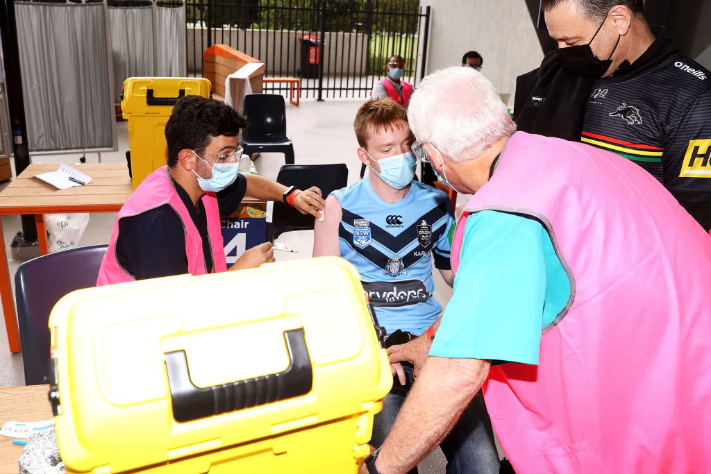 Shay Bell receives a vaccine at a pop up COVID vaccination booster clinic inside the stadium before  the match between the Men's Indigenous All Stars and the Men's Maori All Stars at CommBank Stadium in Sydney, Australia, on Feb. 12, 2022. (Mark Kolbe/Getty Images)