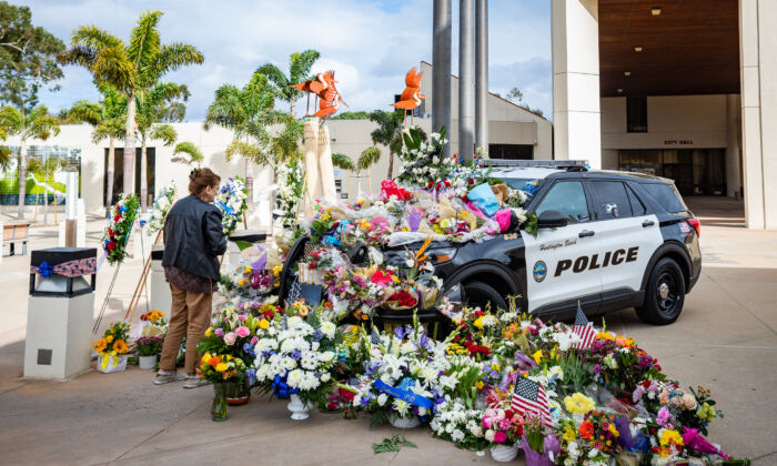 A growing memorial of flowers for the passing of Huntington Beach Police Officer Nicholas Vella is displayed near the Huntington Beach Police station in Huntington Beach, Calif., on Feb. 22, 2022. (John Fredricks/The Epoch Times)