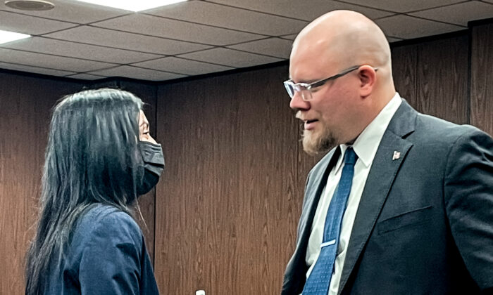 Michigan’s assistant attorney general, Sunita Doddamani, and FBI agent Henrik Impola during a break in the state entrapment hearing for the Whitmer kidnapping plot, in Jackson, Michigan, on Feb. 23, 2022. Impola was accused of perjury in a separate case. (Ken Silva/Epoch Times)