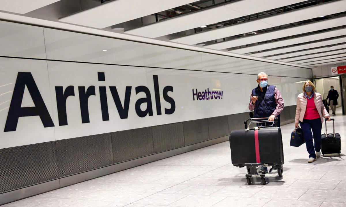 People arrive at Heathrow airport in west London on Nov.30, 2021. (Adrian Dennis/ AFP via Getty Images)