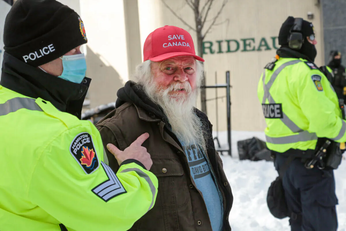Mike Jamieson, from Windsor, Nova Scotia, is arrested for refusing to move his truck at the Ottawa blockade on Feb. 18, 2022. (Richard Moore/The Epoch Times)