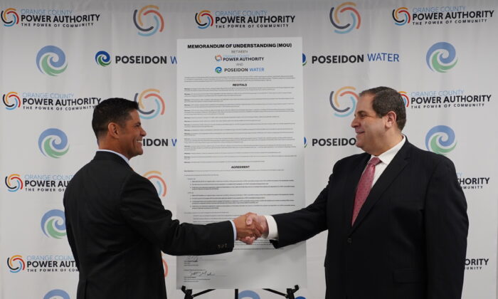 Poseidon Water Vice President Scott Maloni (L) and Brian Probolsky, CEO of Orange County Power Authority, sign the official Memorandum of Understanding to work together toward making the Huntington Beach Seawater Desalination Plant the first of its kind in the Western Hemisphere to be powered entirely by renewable energy in Irvine, Calif., on Feb. 22, 2022. (Courtesy of Orange County Power Authority)