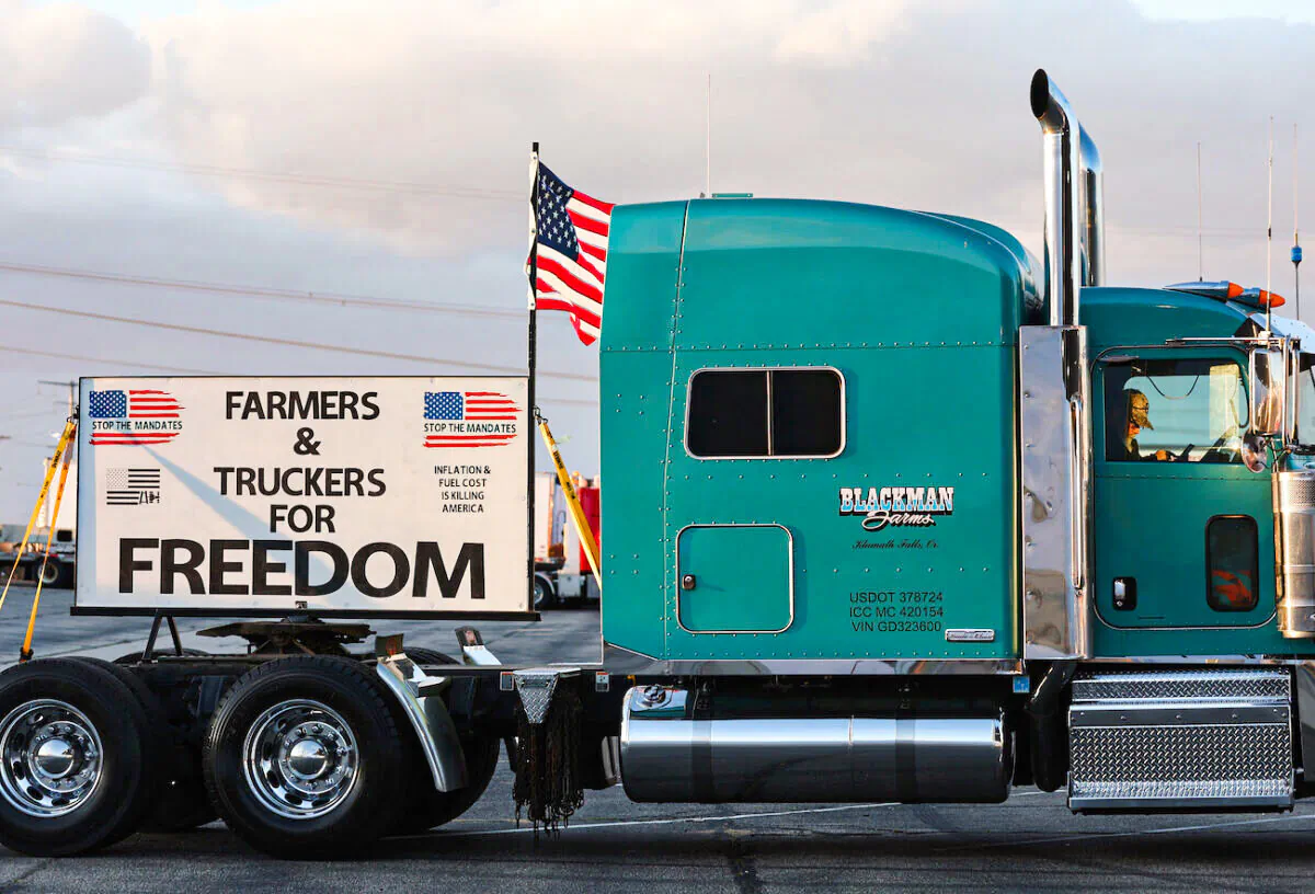 A trucker sits in his cab as truck drivers and supporters gather one day before "The People’s Convoy" departs for Washington to protest COVID-19 mandates, in Adelanto, Calif., on Feb. 22, 2022. (Mario Tama/Getty Images)