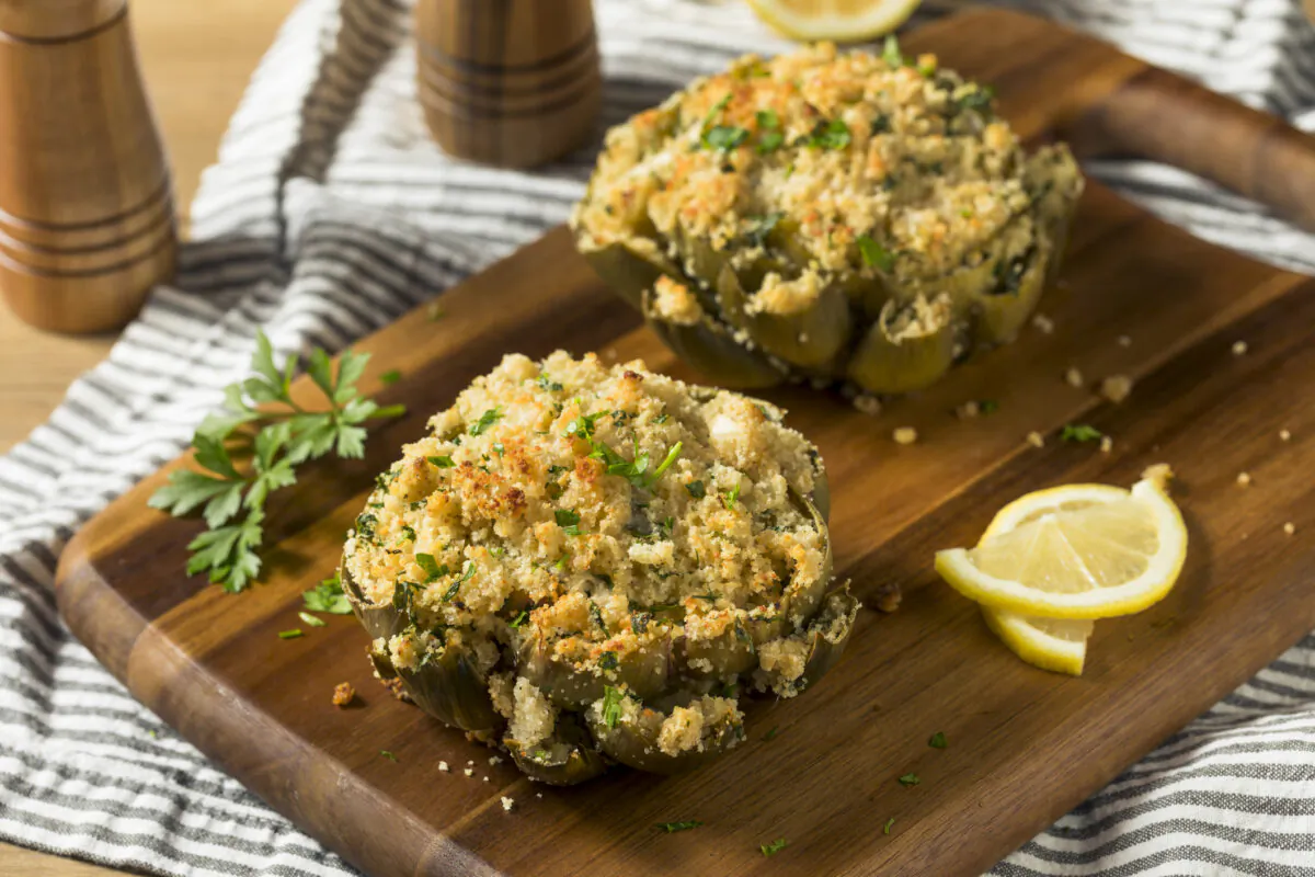 Whole artichokes are stuffed with an Italian-influenced mixture of breadcrumbs, tomatoes, garlic, herbs, and Parmesan cheese. (Dreamstime/TNS)